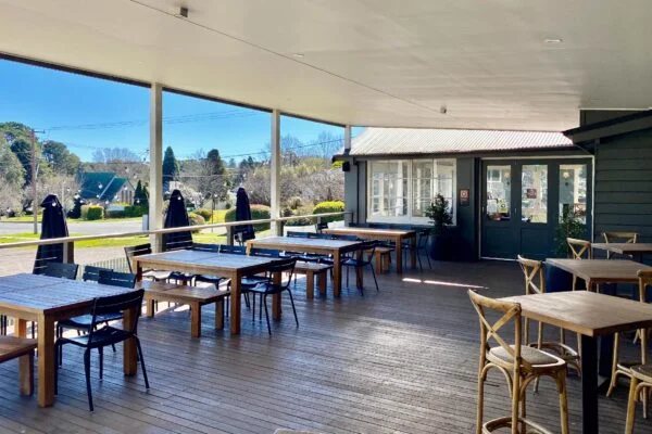 The covered Back Deck with tables and Highlands views