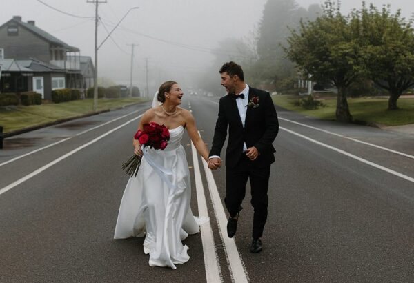 A couple hand in hand on a fog-bound Robertson road